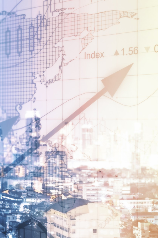 Hands of business people pointing and discussing charts and graphs on printed reports at a desk.