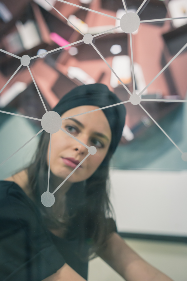 Hands of business people pointing and discussing charts and graphs on printed reports at a desk.