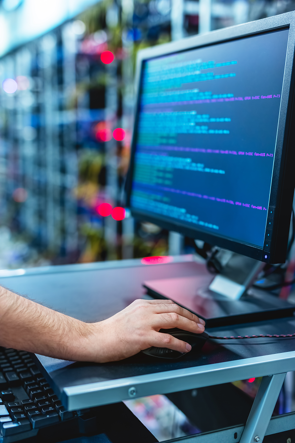 Hands of business people pointing and discussing charts and graphs on printed reports at a desk.