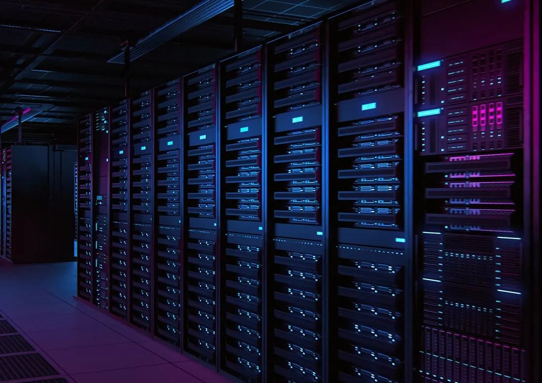 Row of illuminated server racks with blue and purple lights in a dark data center room.