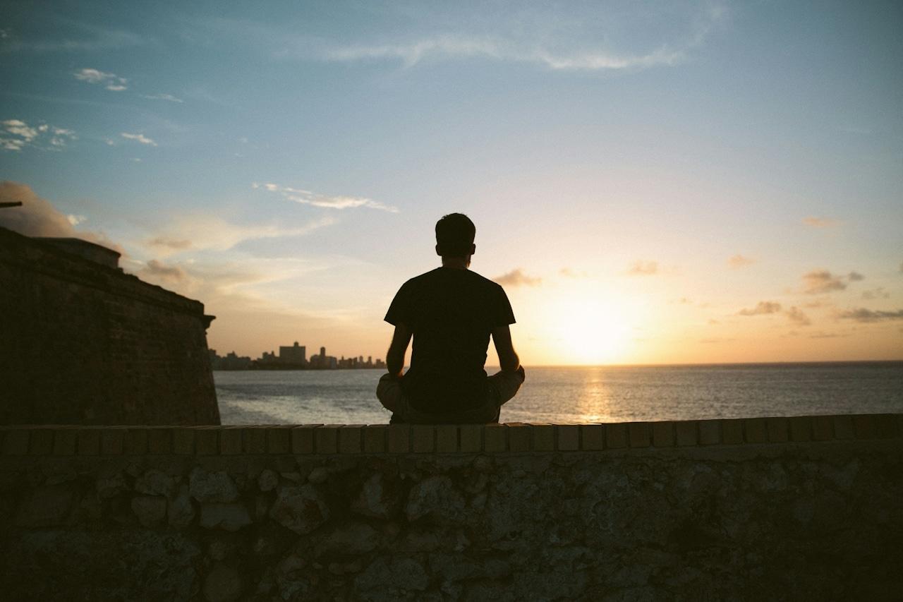 MAN WATCHING THE SUN SET