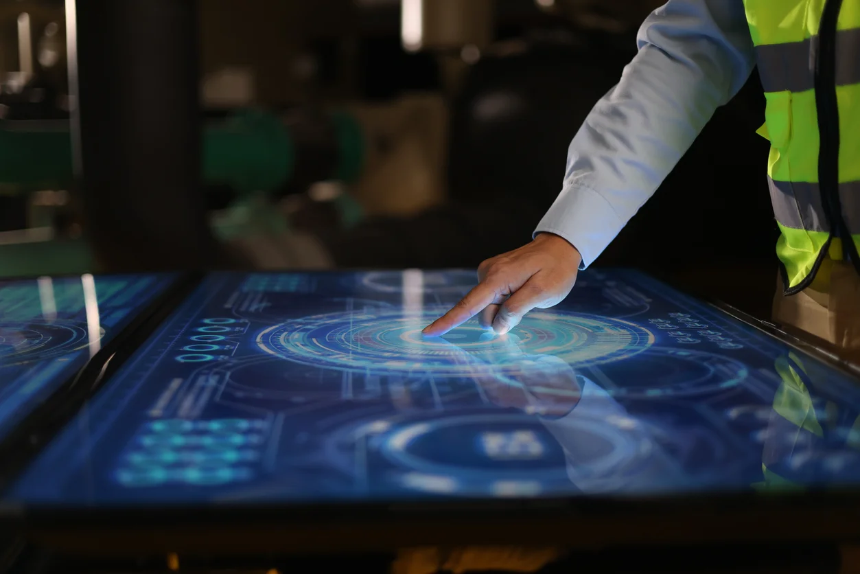 A person pointing at something on a table.