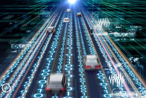 Conceptual illustration of autonomous vehicles on a digital highway, with binary code and data graphics representing AI-driven communication and connected transportation systems.