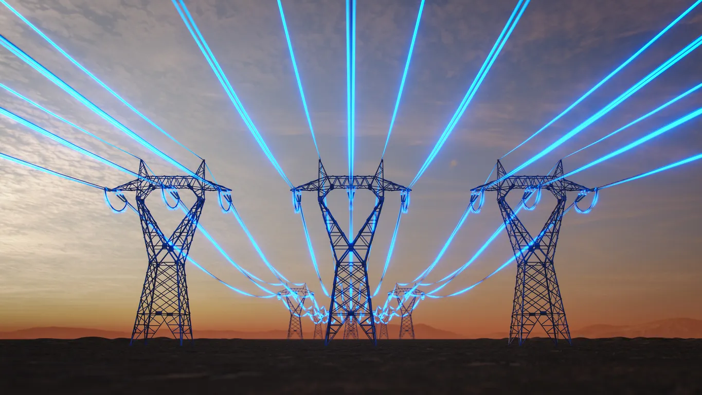 High-voltage power transmission towers carrying glowing blue electric lines across a landscape at sunset, symbolizing energy distribution and smart grid technology.