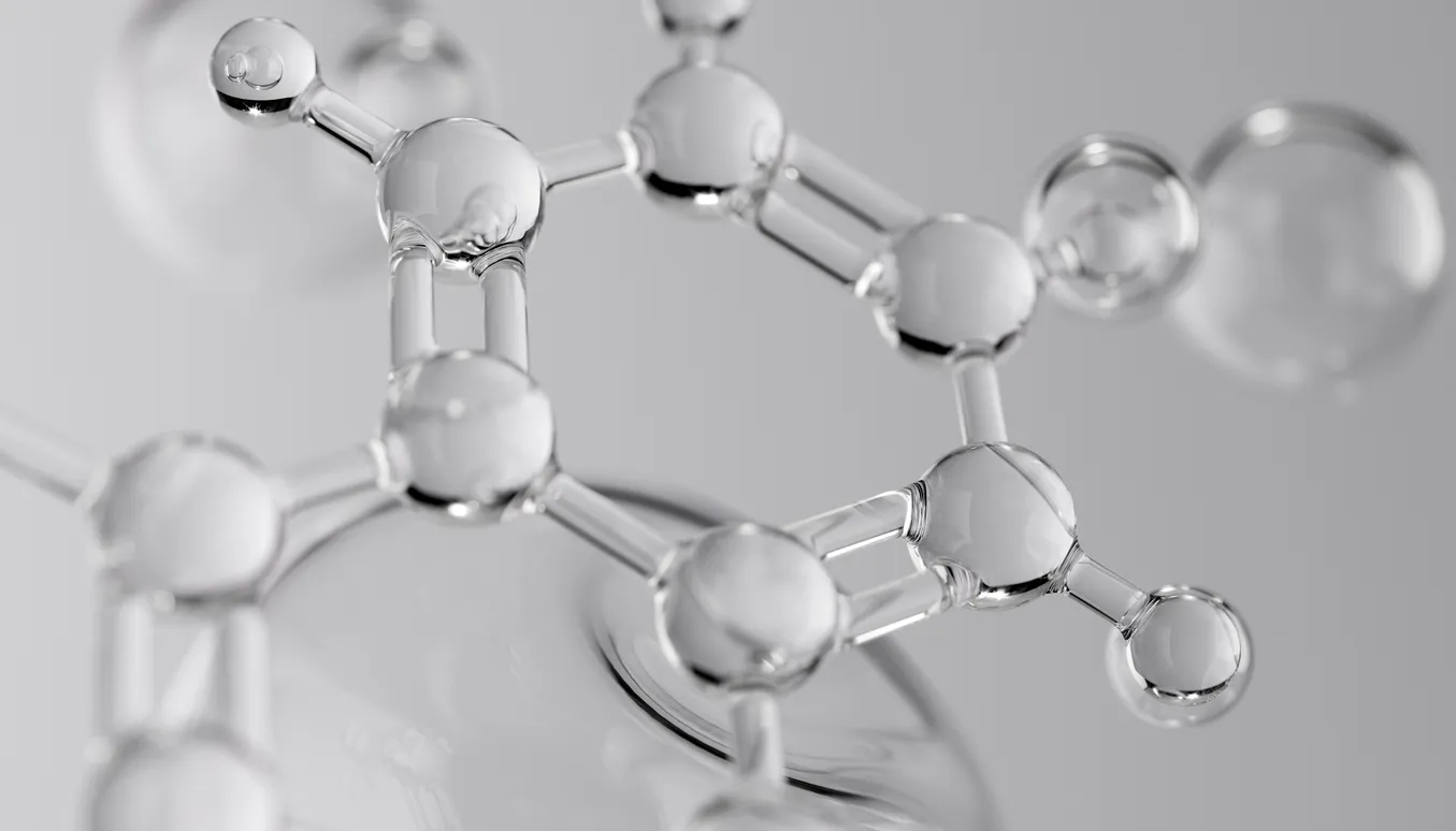 Glass-like molecular structure with interconnecting spheres and rods, set against a soft gray background, conveying a sense of scientific elegance.