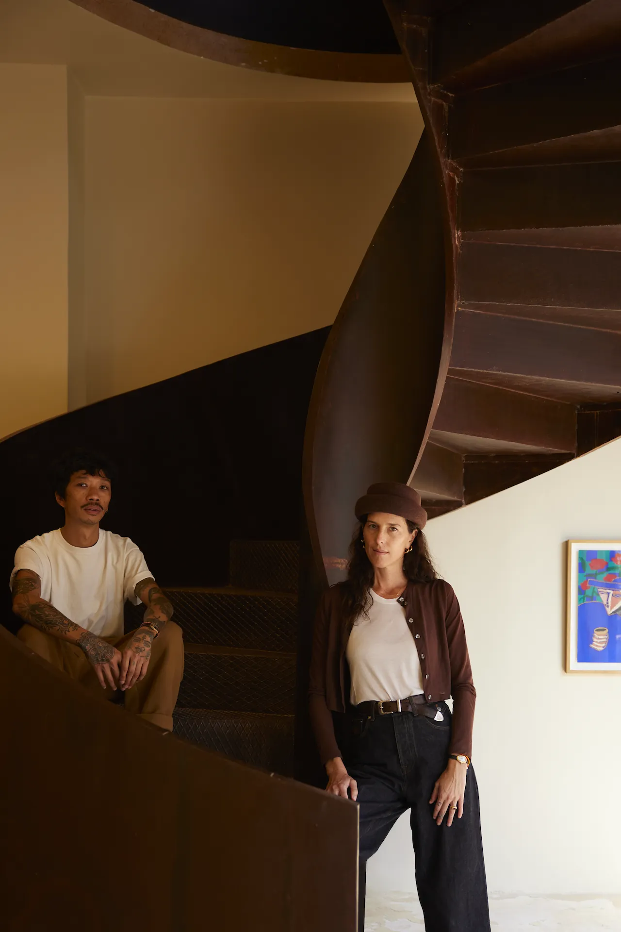 The founders of Rigotang on the steel spiral staircase of the gallery, Marrakech