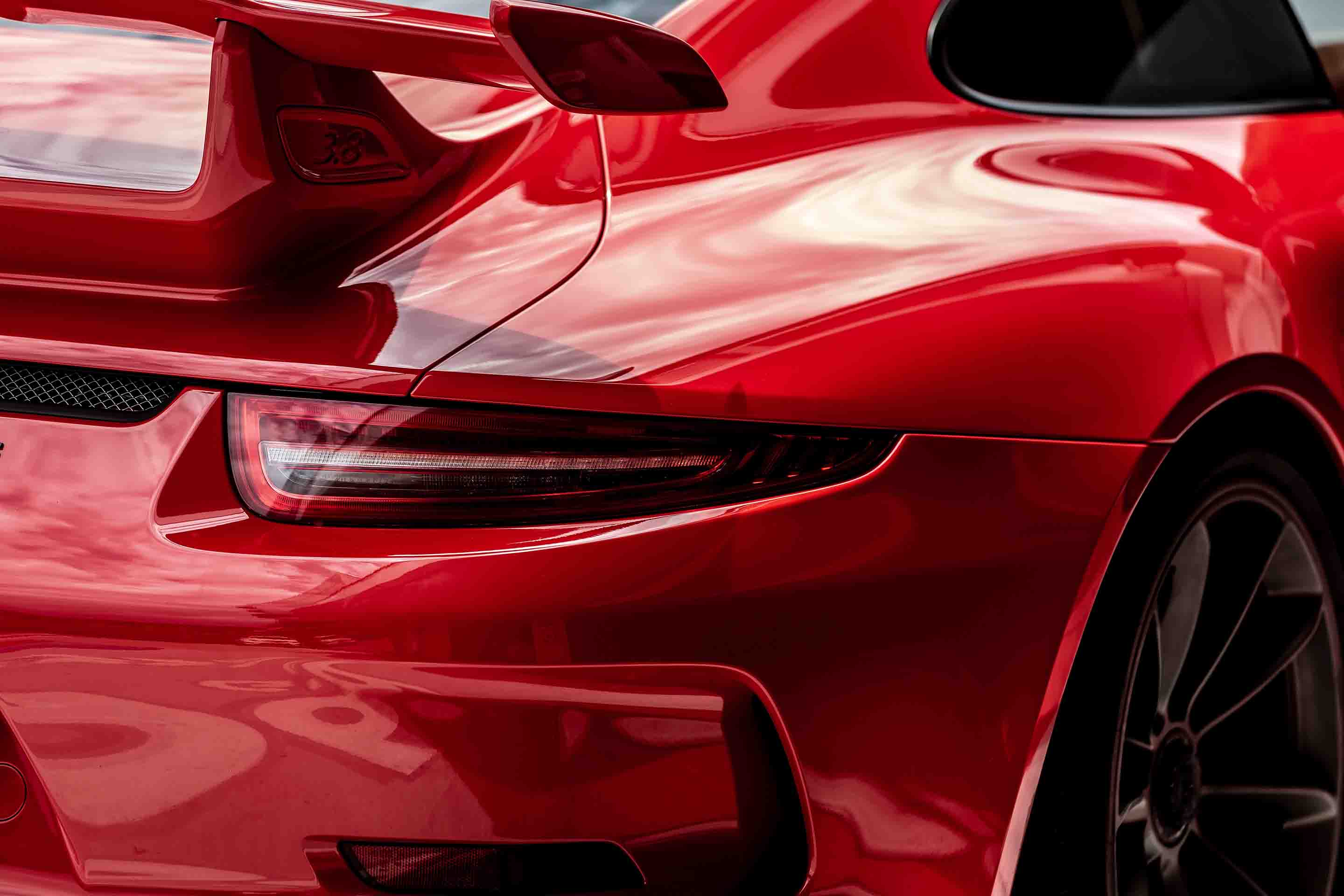 Dent and scratch repair for a red Porche.