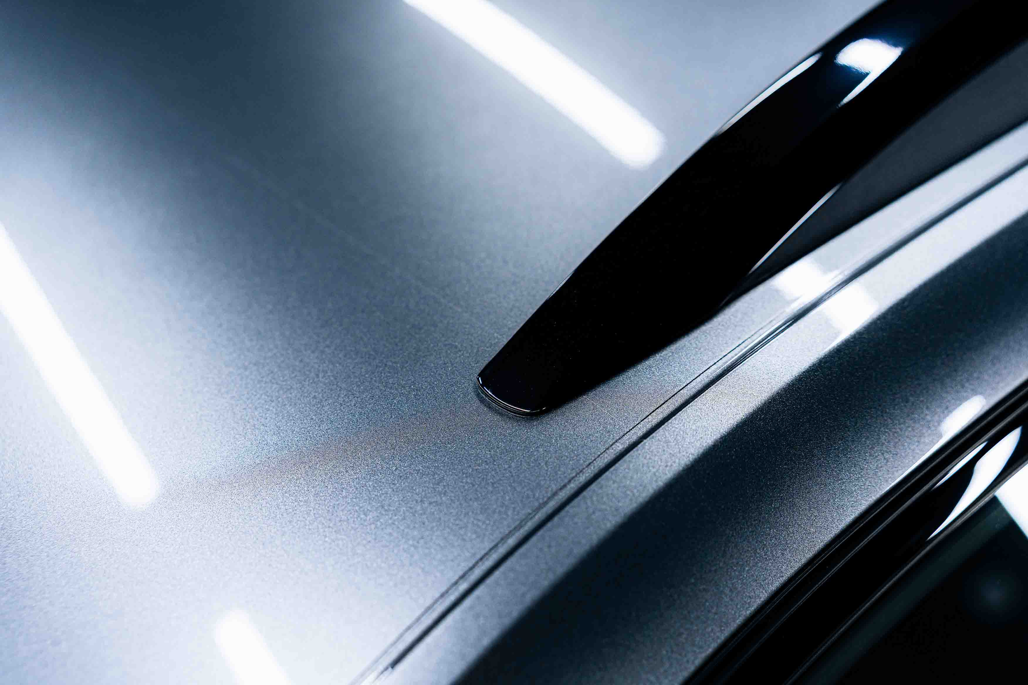 Dent and scratch repair of a grey metallic car.