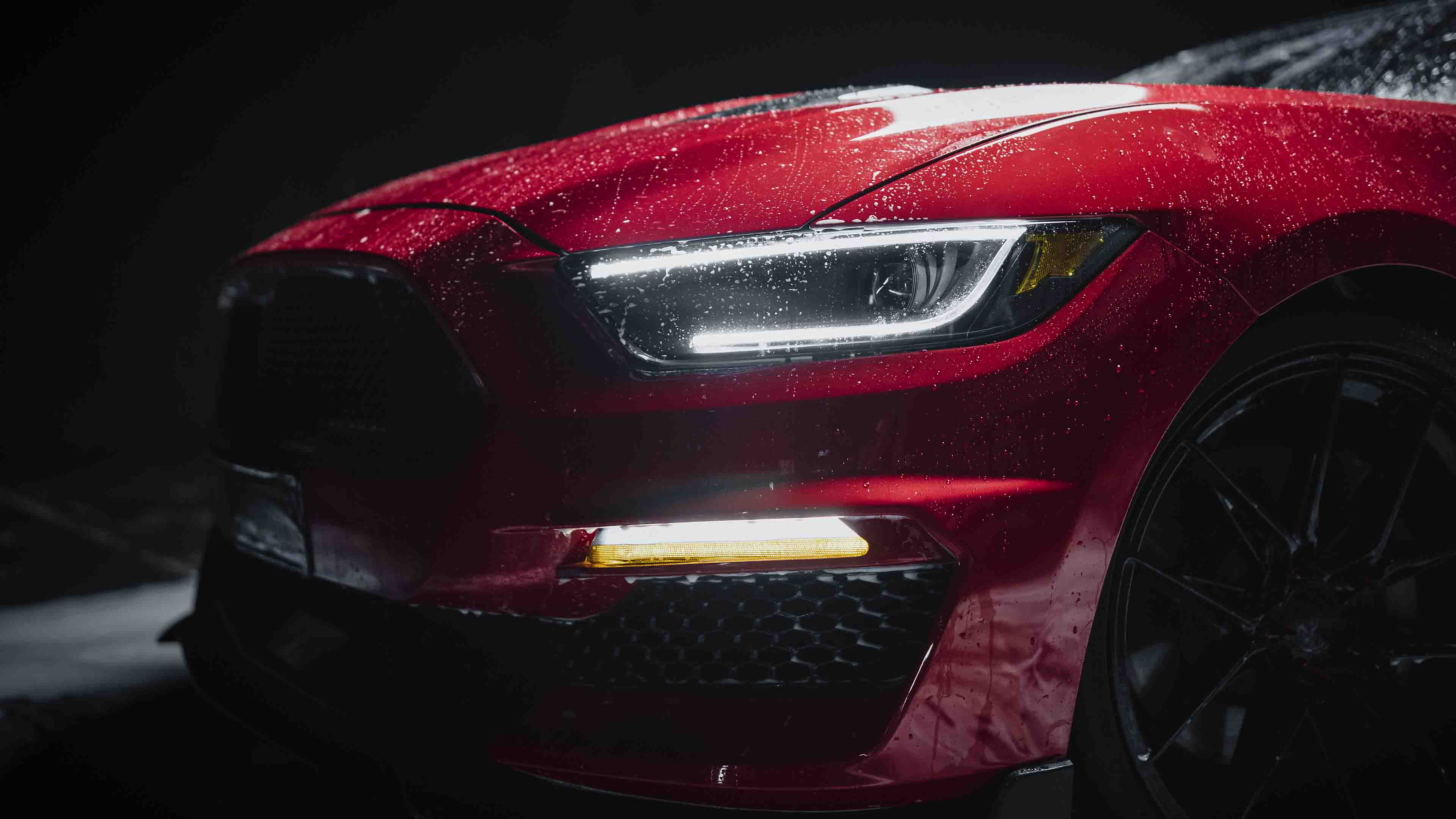 Deep clean. Water droplets covering a red car.