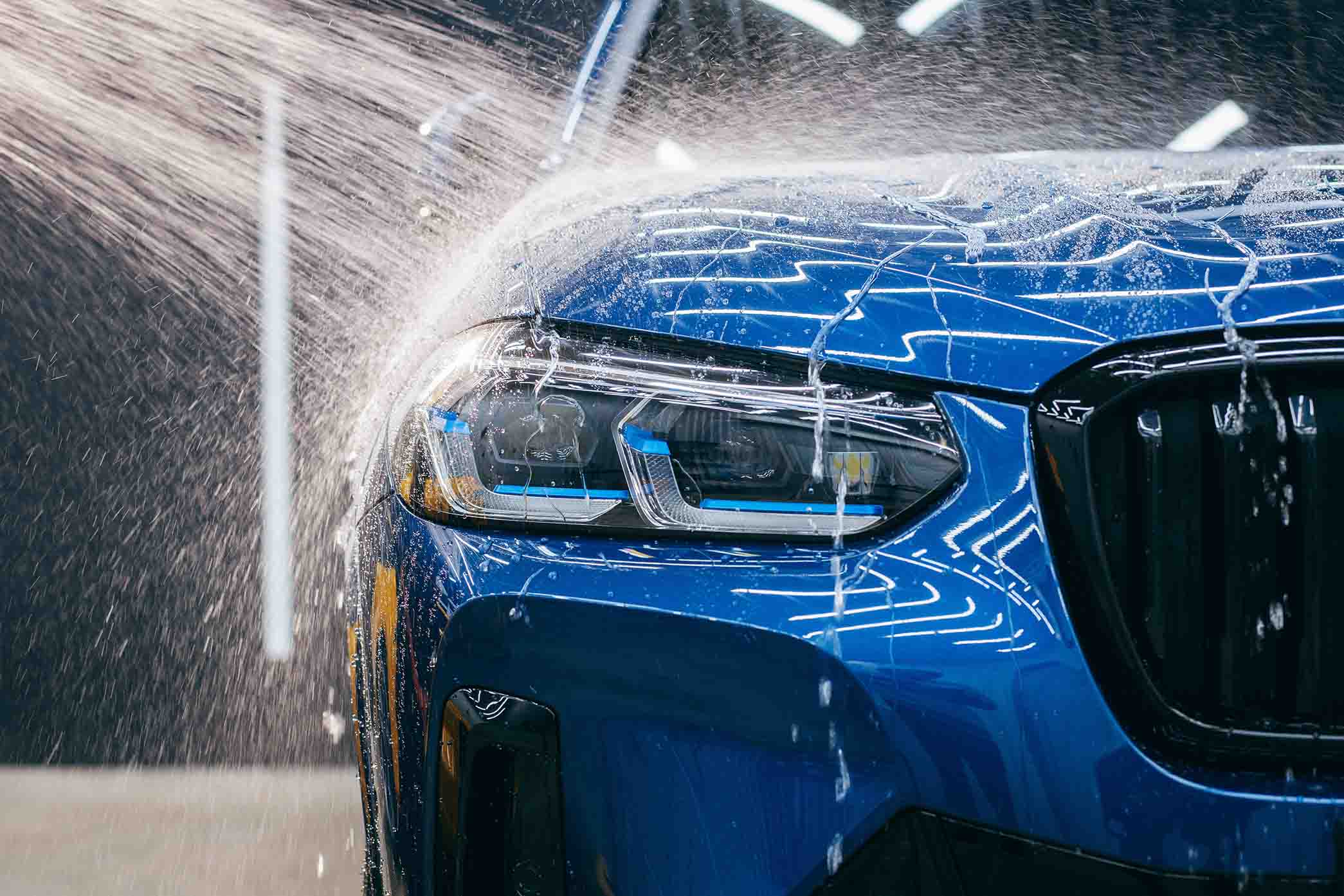 Maintenance clean. Blue car getting a rinse.