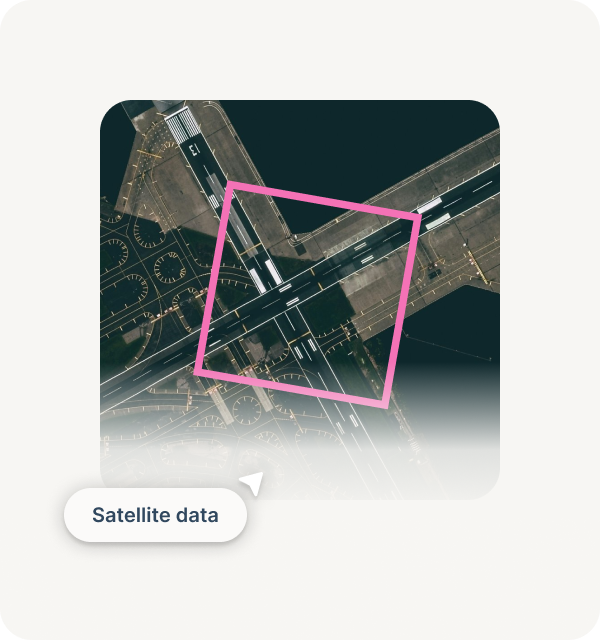 Aerial view of an airport runway and taxiways marked with guidance lines, highlighted by a pink square.