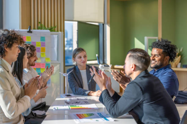 Close-up of two people shaking hands in a professional setting, symbolising trust, agreement, and partnership.