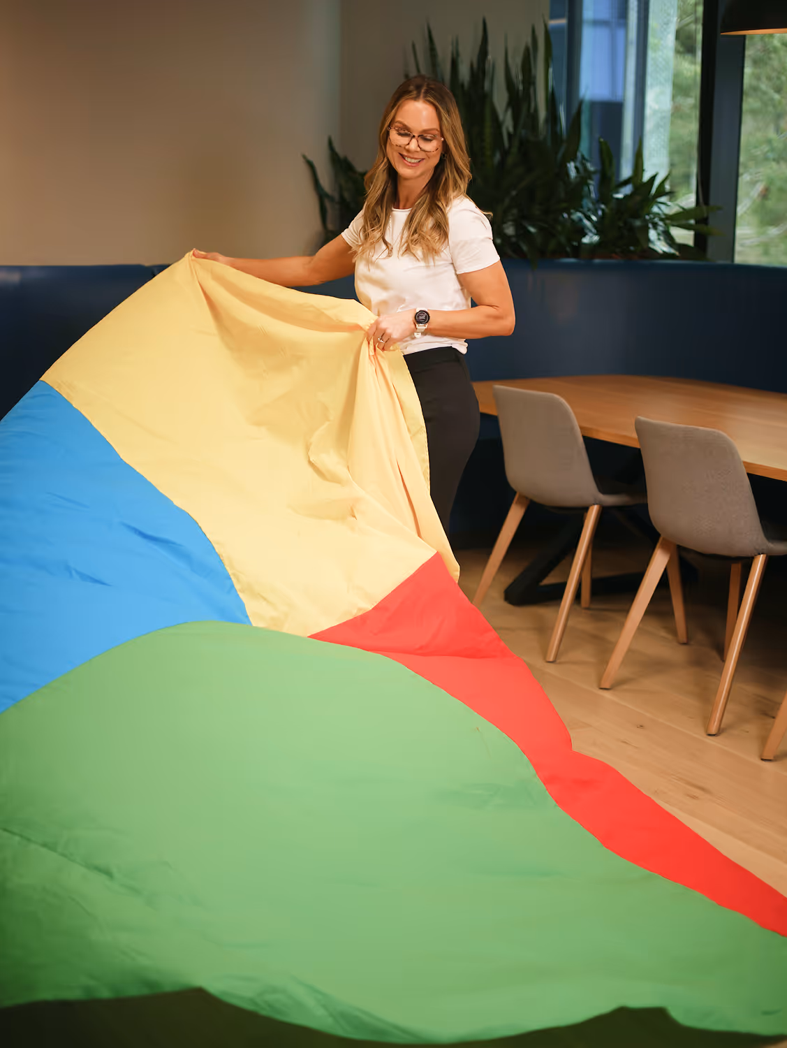 Colleagues collaborating at a table while reviewing documents together.