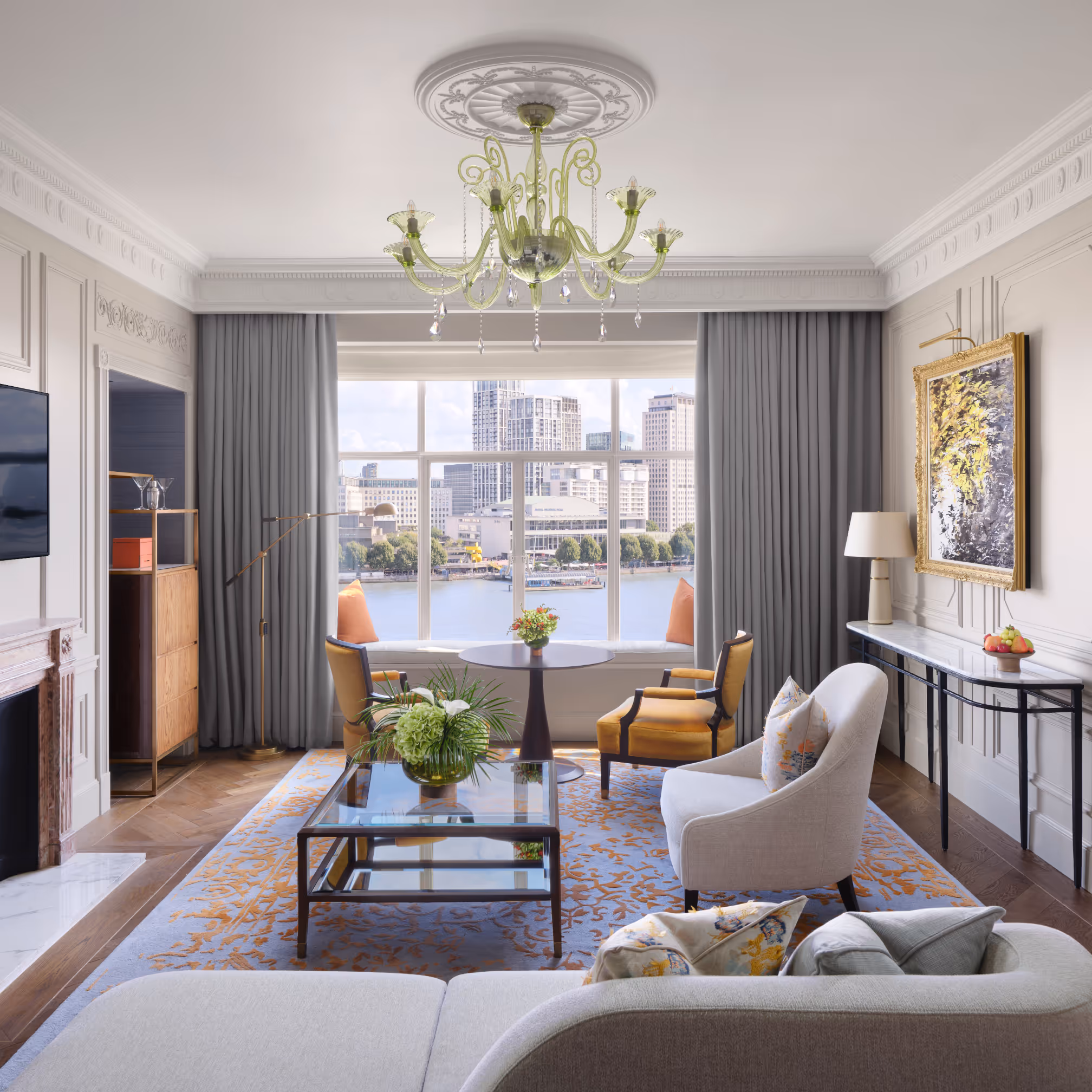 Luxurious living room with large window overlooking city skyline and river with modern seating.