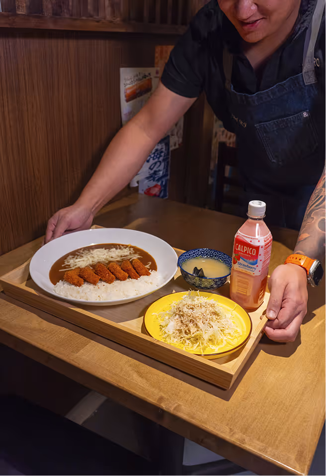 Curry Ya Food tray brought out by waiter