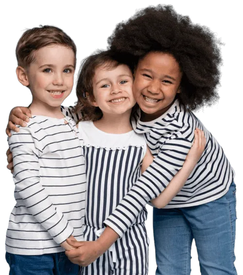 Three smiling children in striped outfits hugging and having fun together