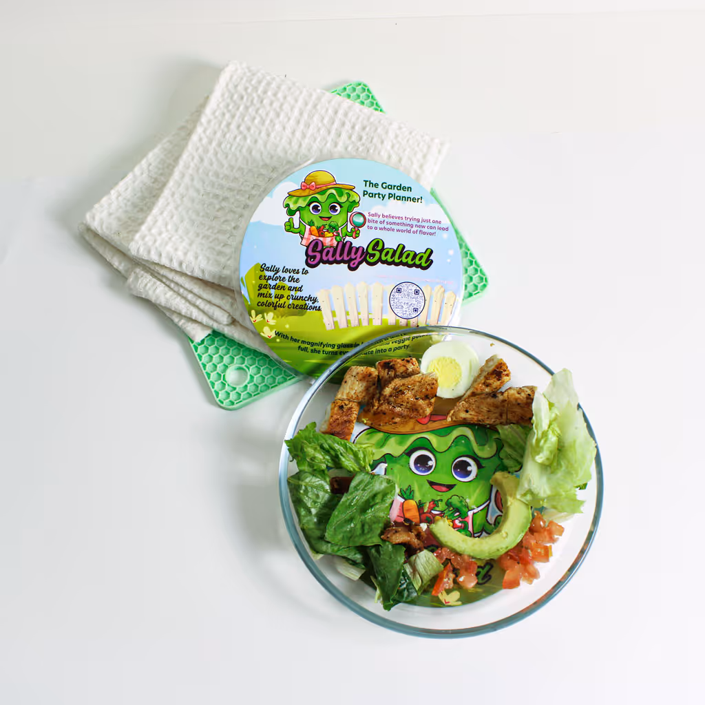 Playful kid-friendly Cobb salad styled as Sally Salad with smiling face made from eggs, bacon, and veggies on a clear plate.