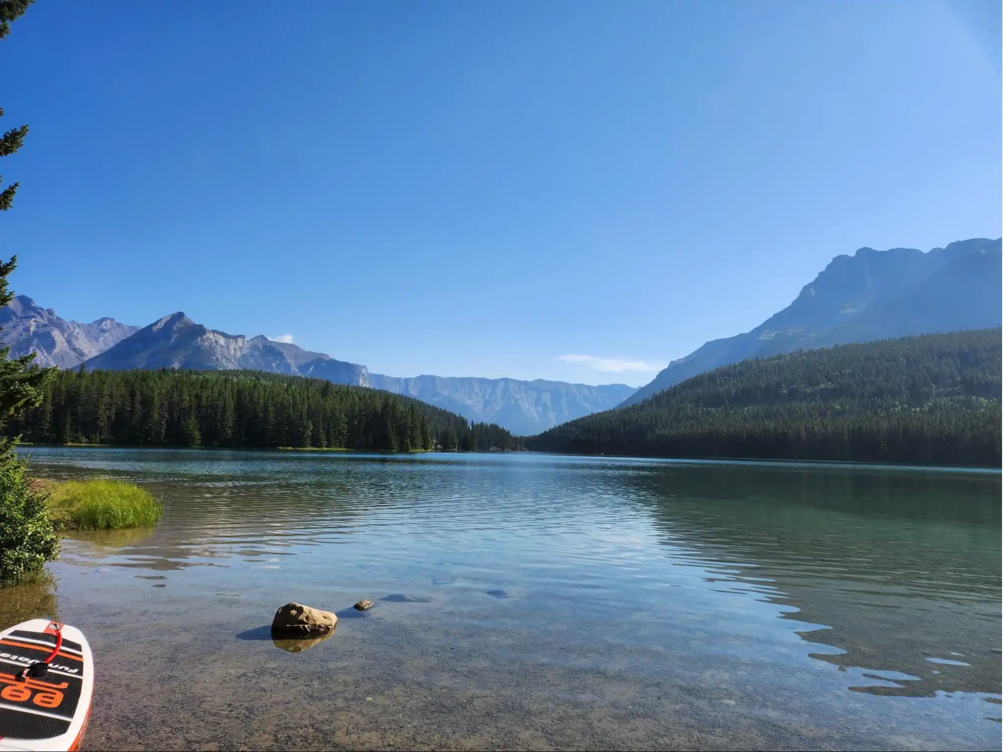 Calm lake with mountains in the background