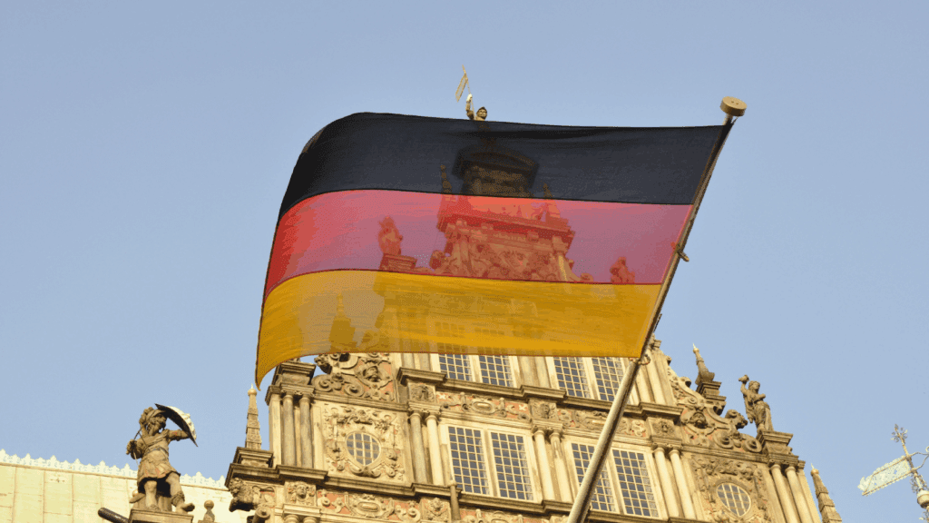 An image of German flag with building in the background.