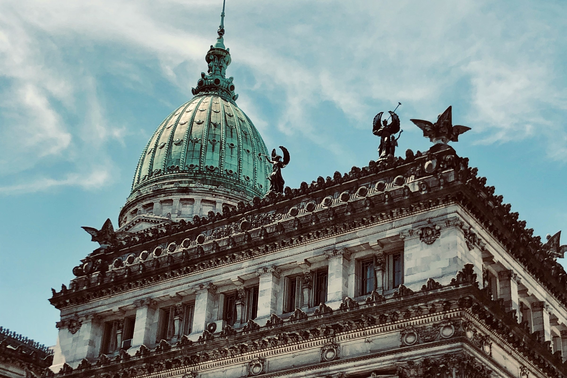 Green dome and ornate stone facade of the Argentine National Congress building in Buenos Aires