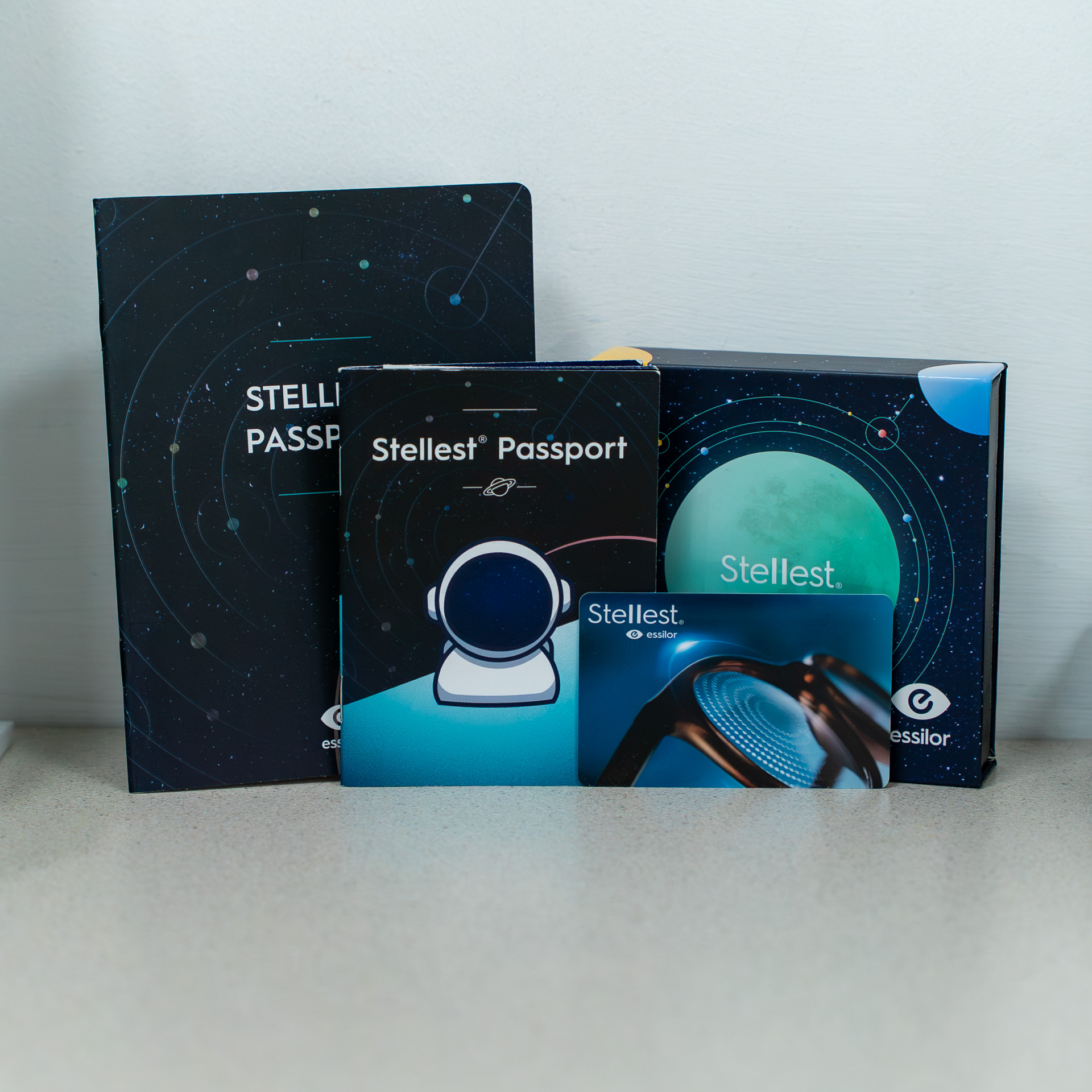 Stellest Passport product boxes arranged together featuring space-themed designs and branding.