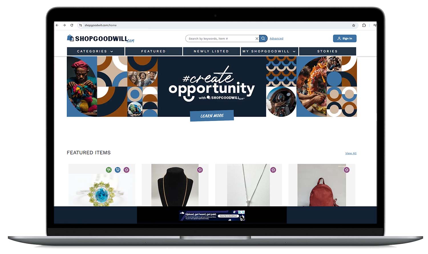 ShopGoodwill.com homepage on a laptop screen showing navigation menus, a #create opportunity banner, and featured items including jewelry and a red backpack.