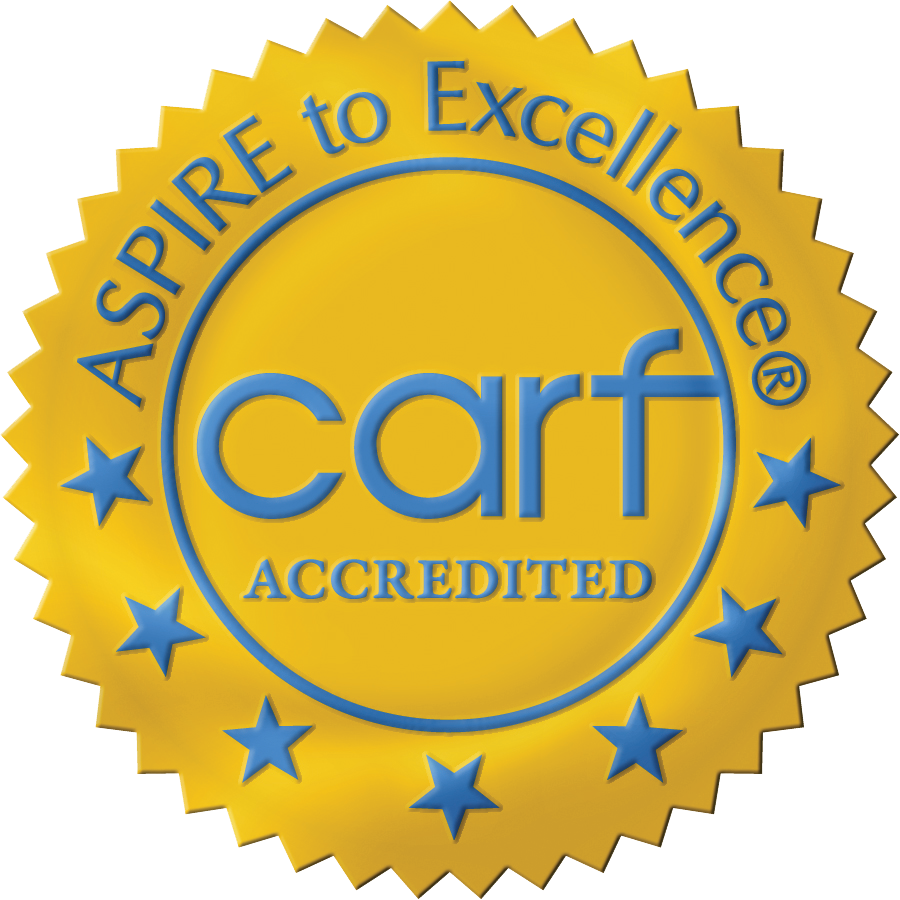 Gold seal with blue text reading 'ASPIRE to Excellence® CARF ACCREDITED' surrounded by blue stars.