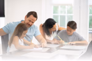 A family doing homework at the table.