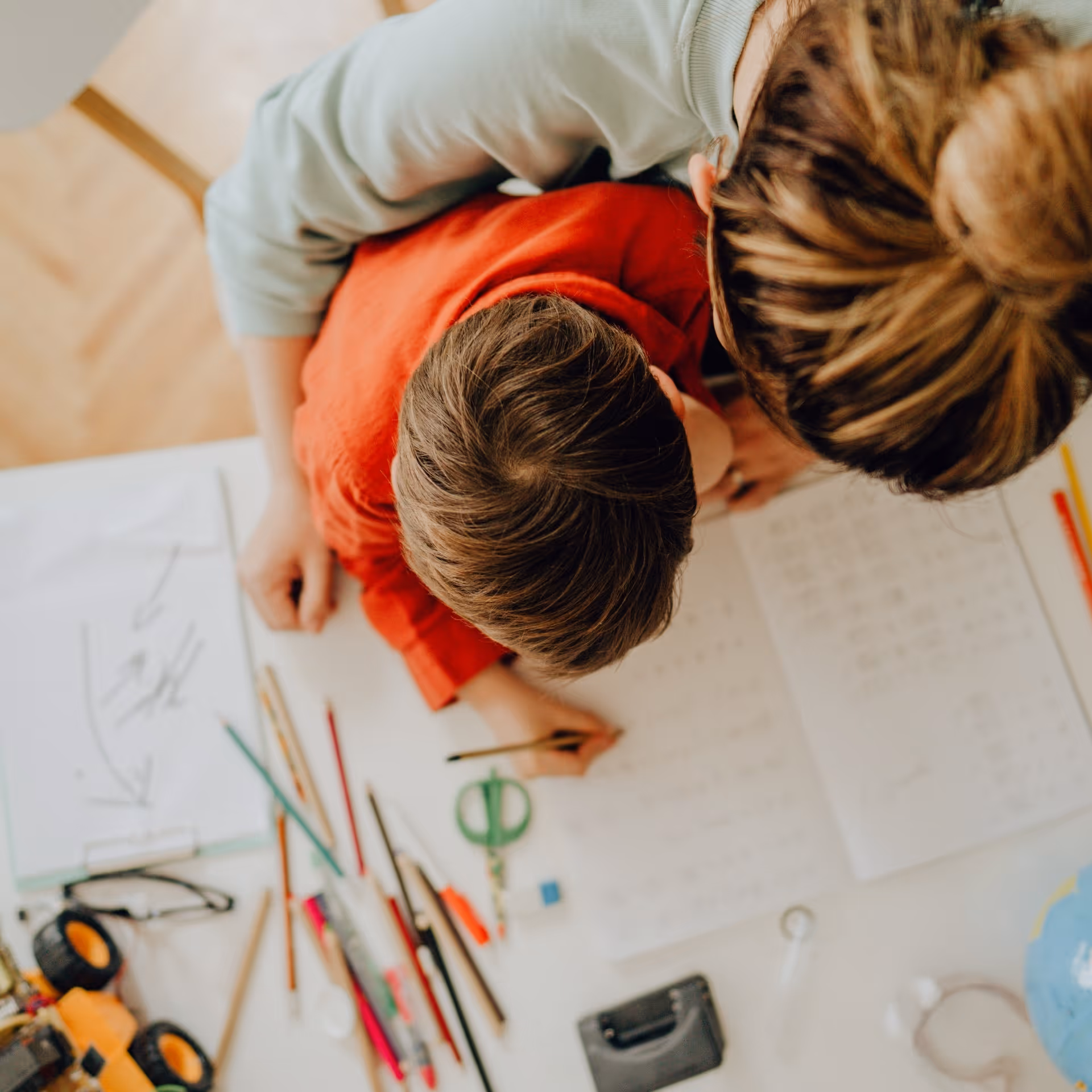 A birdseye view of a mom and son doing homework.
