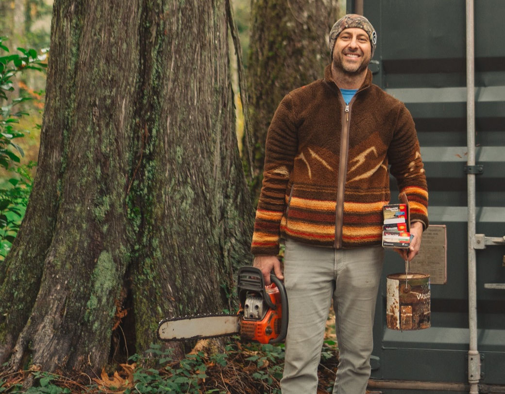 Nick Pietsch, owner of Index Cabins, among the trees beside one of his cabins in Index, Washington