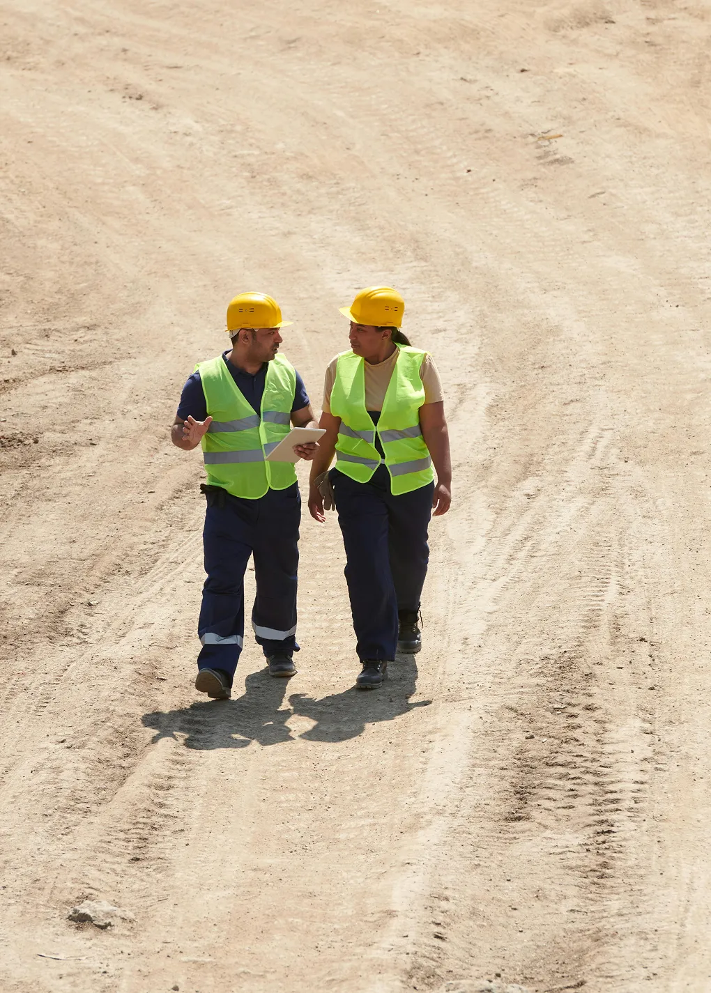 Construction workers standing on a job site, reviewing project plans