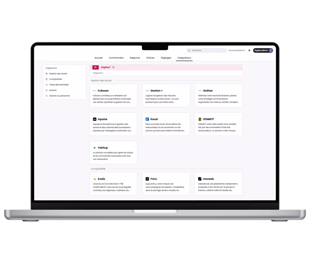 Ordinateur portable affichant un tableau de bord d'intégrations pour la gestion des stocks, comptabilité et facturation avec plusieurs options logicielles.