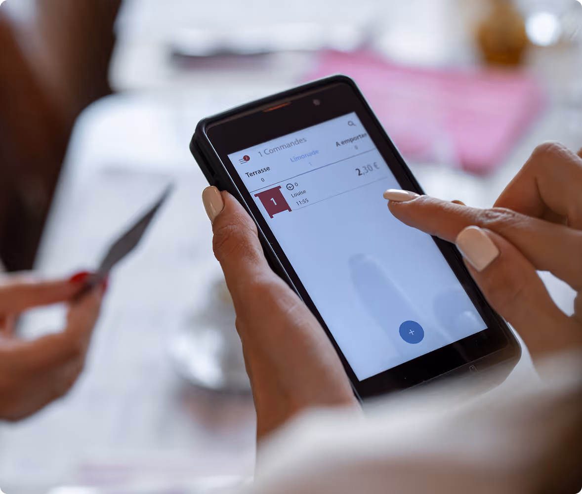 Dans un restaurant, sur une télécommande Popina Pad, le serveur prend la commande et le paiement depuis le même terminal