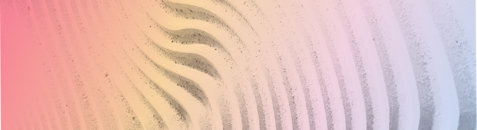 Softly lit sand with curved, wavy ridges transitioning from pink to blue hues.