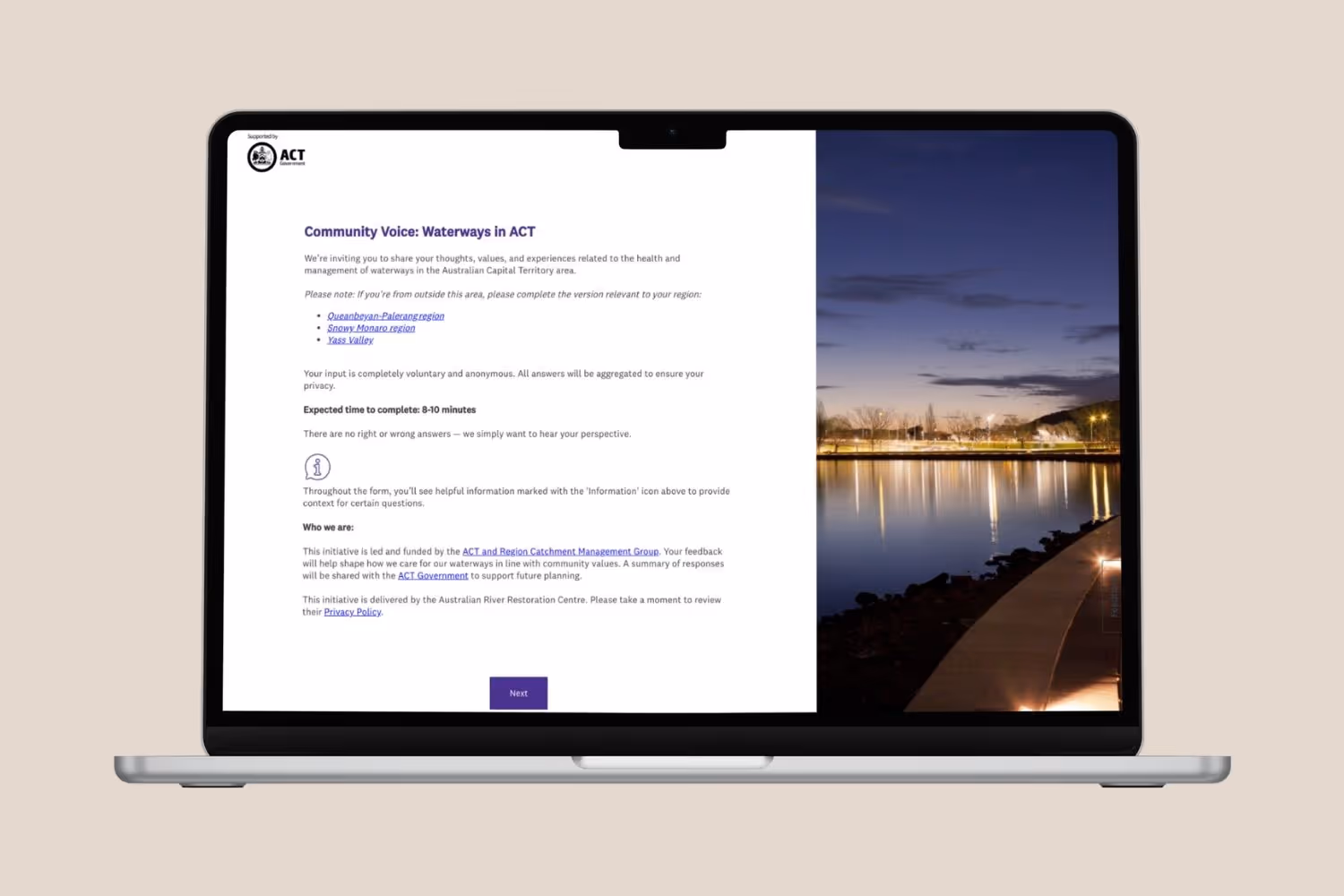 Laptop screen showing a survey titled 'Community Voice: Waterways in ACT' with details about the survey and a night photo of a riverside walkway on the right side.