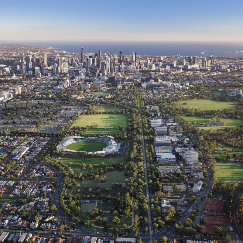 Aerial view of Melbourne skyline, Albert Park and Port Phillip Bay on a clear day.