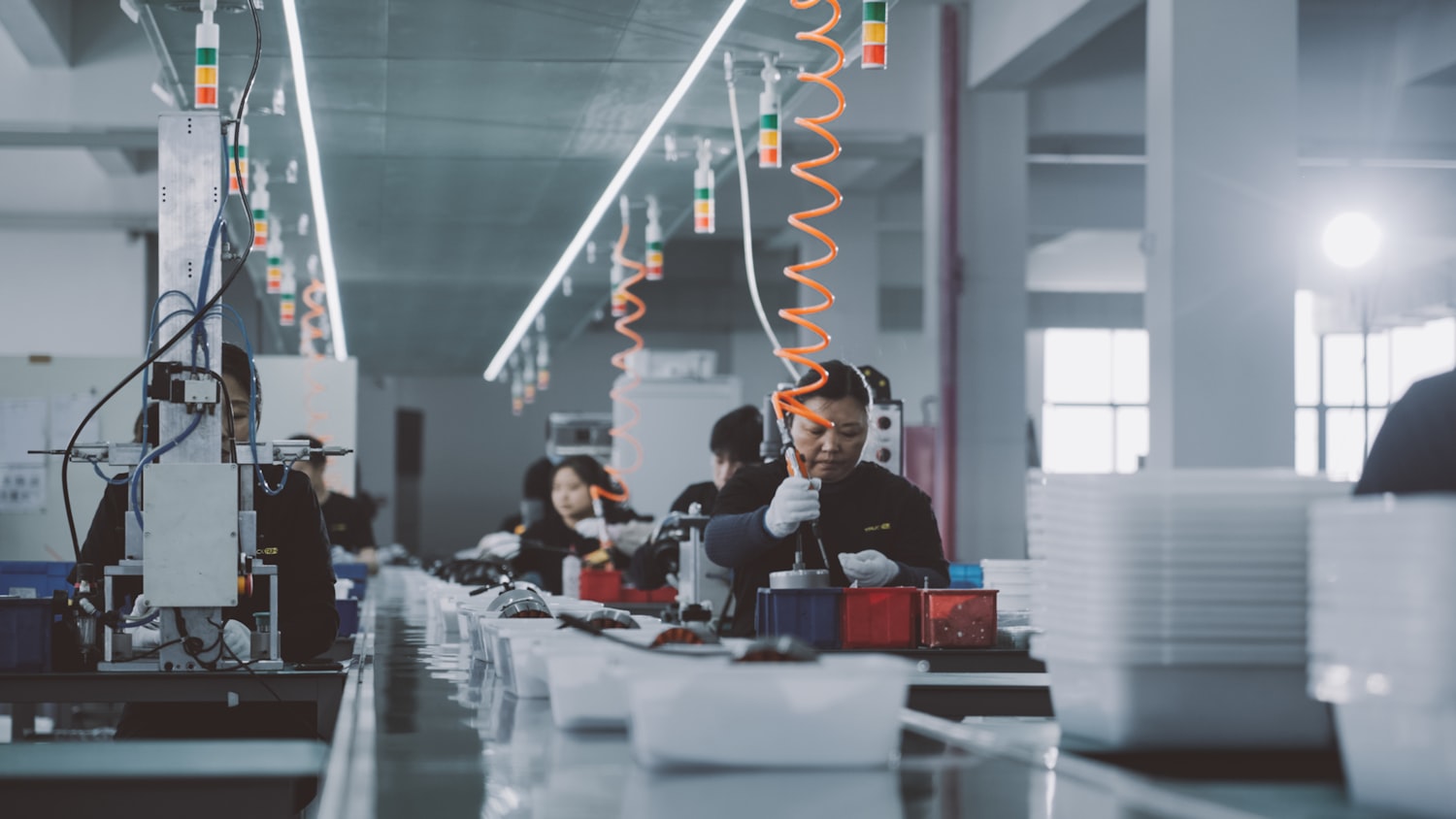 Technicians monitor automated manufacturing systems, representing the skills demand across coalition members