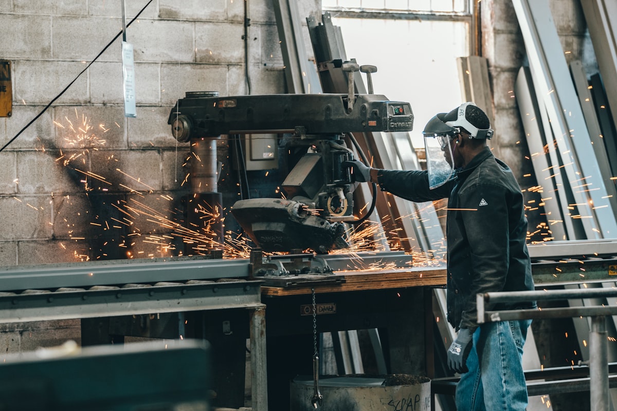 A technician working on a machine inside a factory