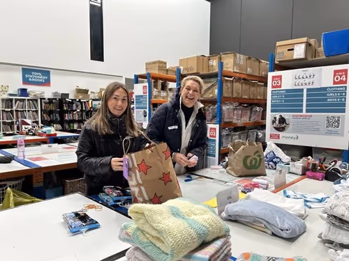 Two people in a warehouse doing crafts.