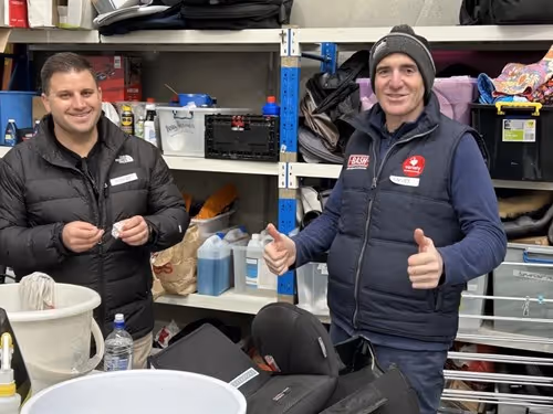 People in a warehouse with thumbs up.
