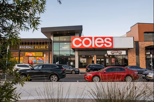Image of shopping centre Coles with cars in the foreground.