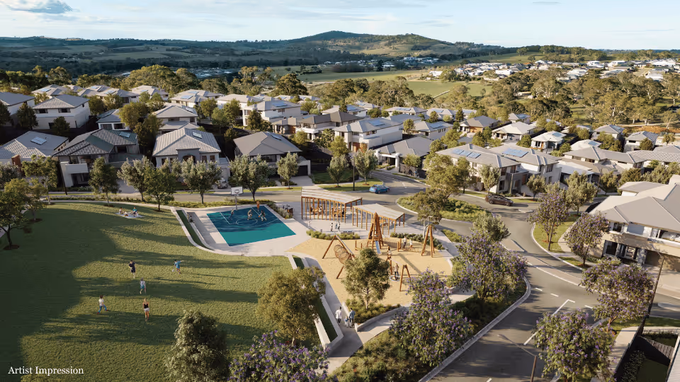A suburban park with a playground, basketball court, and open green space surrounded by modern homes and hillside views.