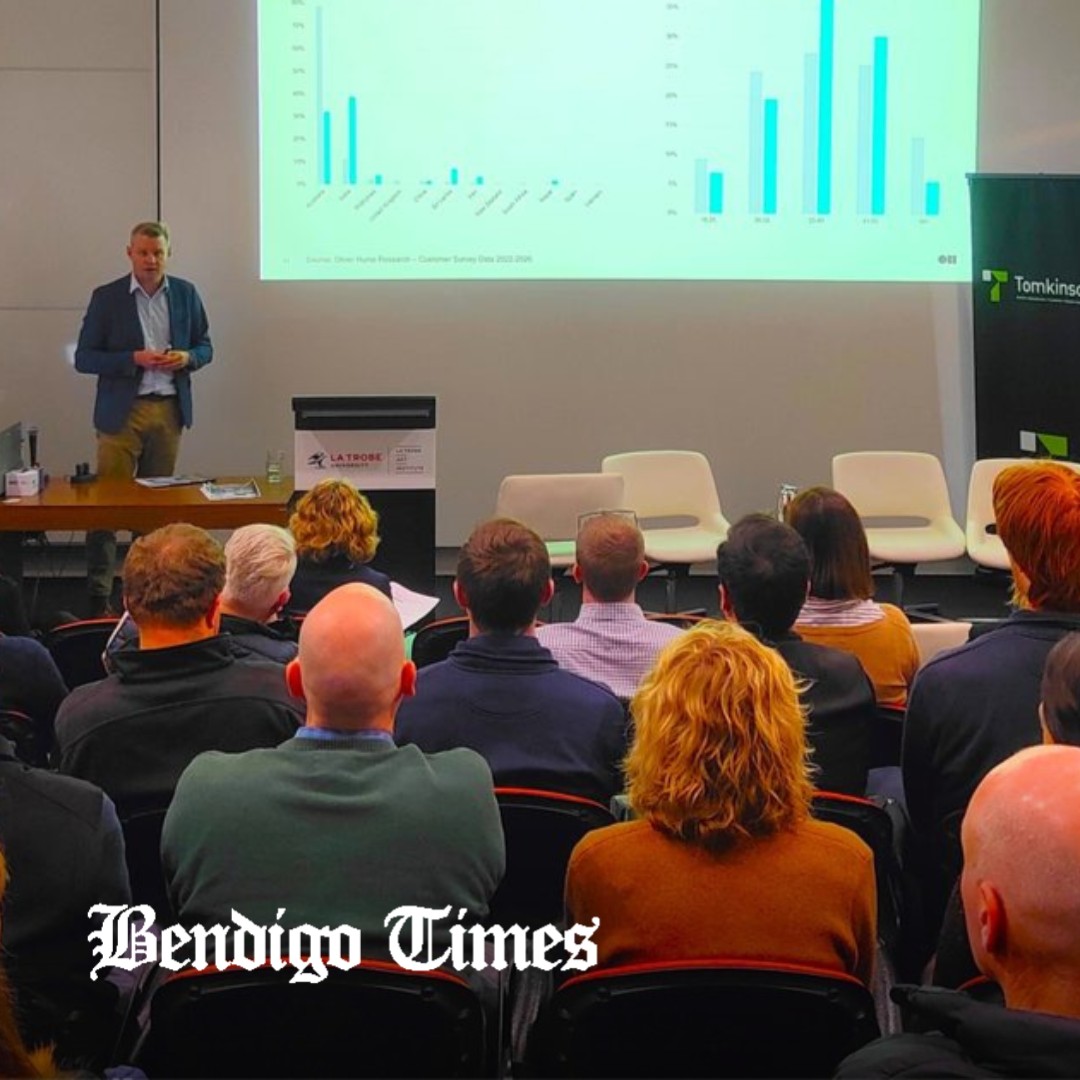 Oliver Hume Chief Economist Matt Bell presenting bar charts to a seated audience at La Trobe Art Institute, with the Bendigo Times logo