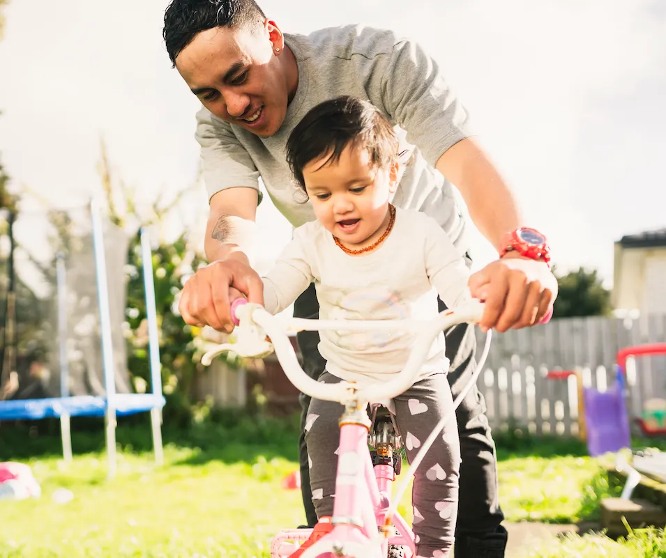 Father teaching his child how to ride a bike