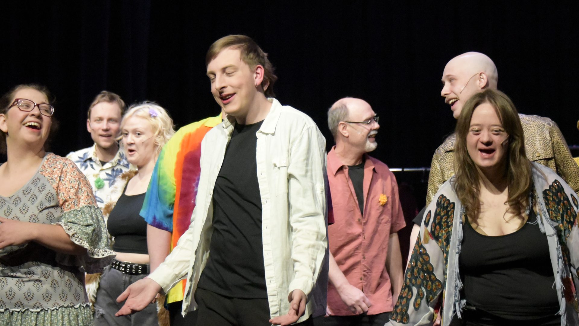 The Godspell Jr. cast laughing together on stage