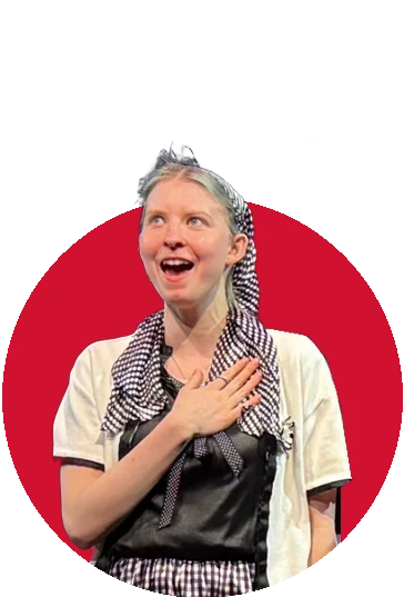 A Tapestry actor in a white sweater and gingham scarf, hand on her heart, in Bye Bye Birdie
