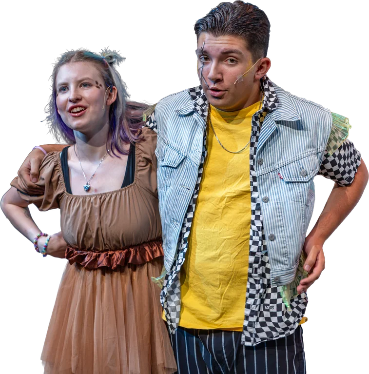 Two Tapestry actors stand arm in arm on stage, smiling out at the audience