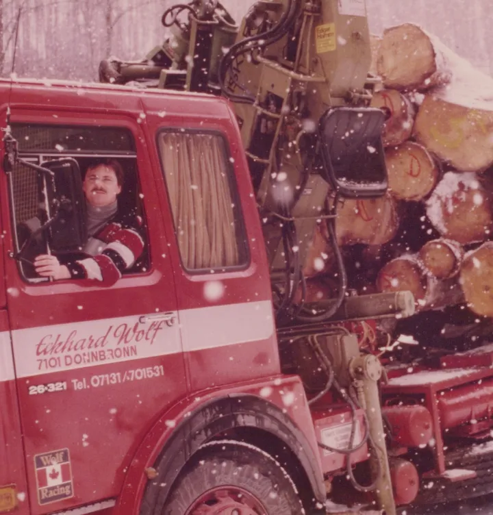 Holzhandel Wolf. Roter LKW im Winter bei Schneegestöber. Caroline Wolf Immobilien