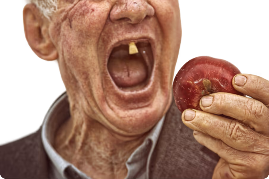 Nahaufnahme eines Mannes mit vielen Zahnlücken, der in einen roten Apfel beißt.