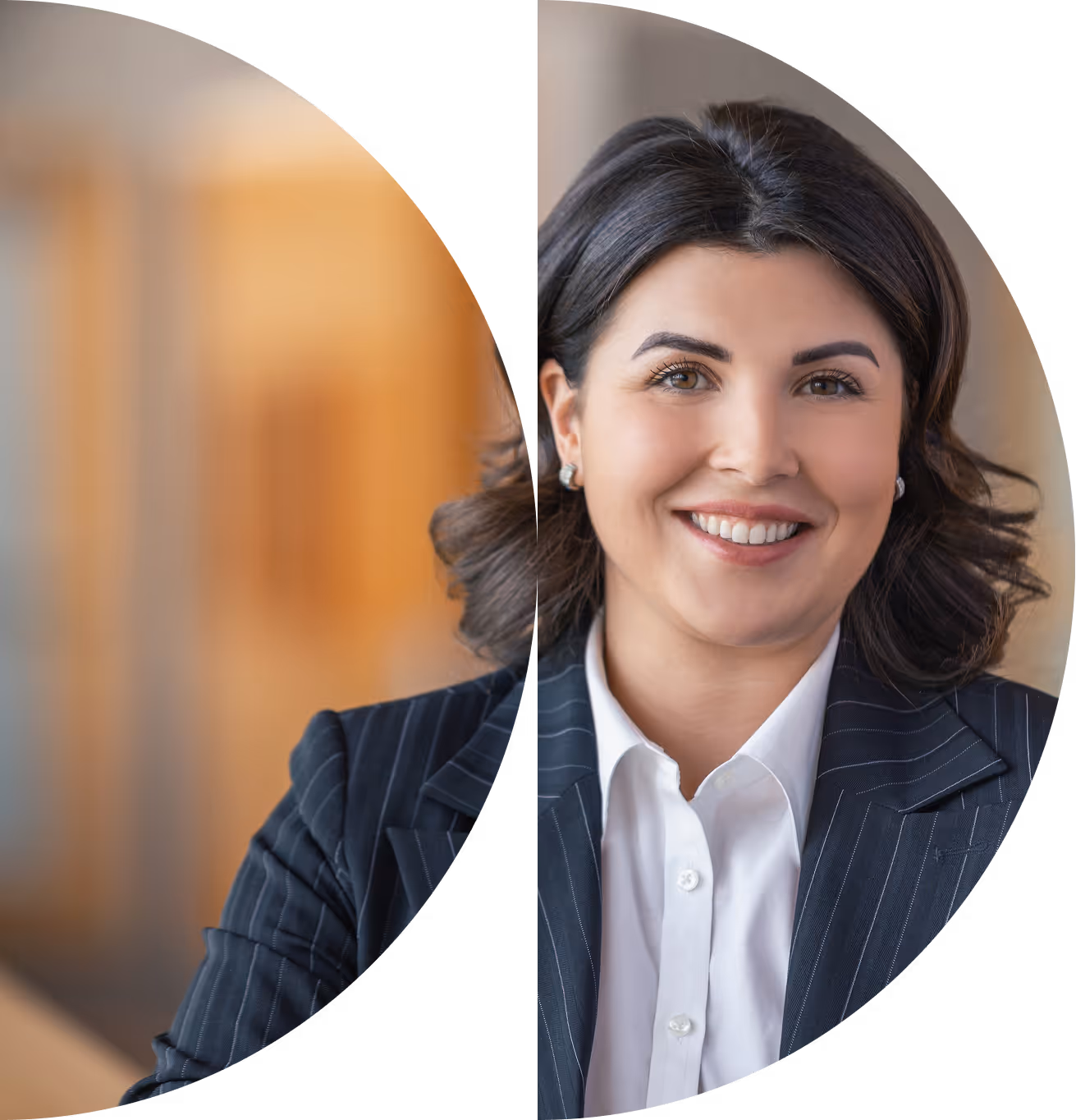A woman with dark hair and wearing a suit smiling